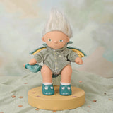 Plush dragon griffin baby doll with white hair and wings on a display stand.