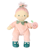 Olli Ella Cozy Dinkum Doll Piper Peach in a peach velour suit holding a plush peach rattle.