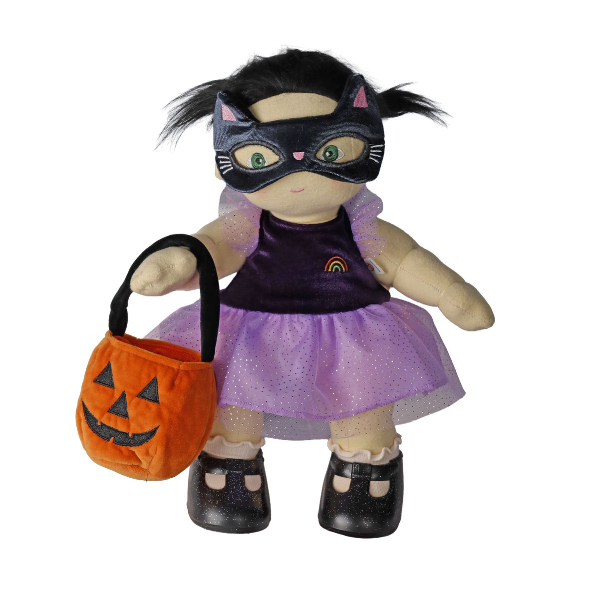 Plush doll in a cat mask holding a pumpkin treat bag, set against a white background.