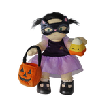 Plush doll in a cat mask holding a pumpkin bag and candy corn plush against a white background.
