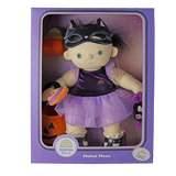 Plush doll dressed in a cat mask and purple outfit inside its original product packaging.