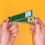 Hands flipping through a filmstrip-styled dinosaur animation flip book against a bright yellow background.