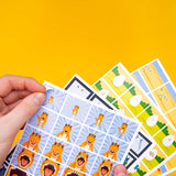 Hands holding dinosaur flip book animation sticker sheets on a bright yellow background.
