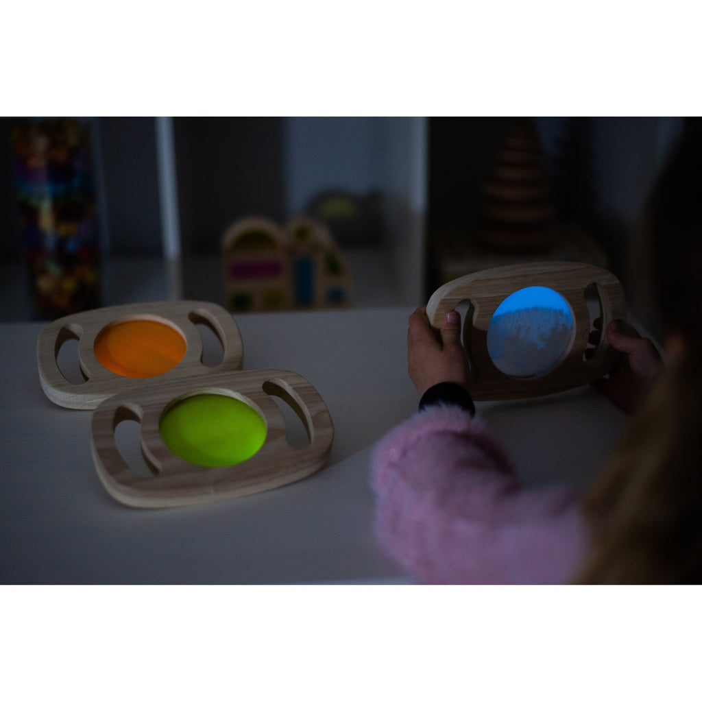 A set of handheld panels with glowing colored centers, designed for sensory play, color exploration, and visual stimulation.