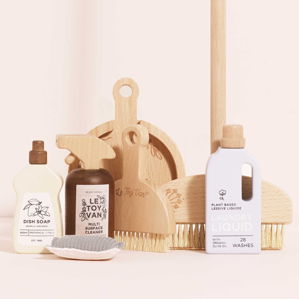 Wooden toy cleaning set featuring dish soap, multi-surface cleaner, and laundry liquid. Includes brushes and a sponge. Neutral tones, playful design.