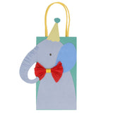 Elephant party bag for kids with blue elephant cutout, yellow party hat, and red crepe paper bow tie on green paper bag.