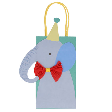 Elephant party bag for kids with blue elephant cutout, yellow party hat, and red crepe paper bow tie on green paper bag.