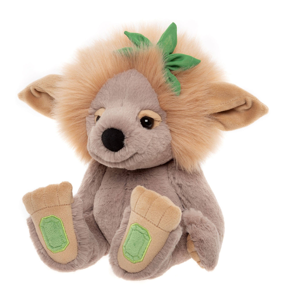 Plush grey troll toy with a fluffy tan mane, large floppy ears, green leaf accent, and large beige feet.
