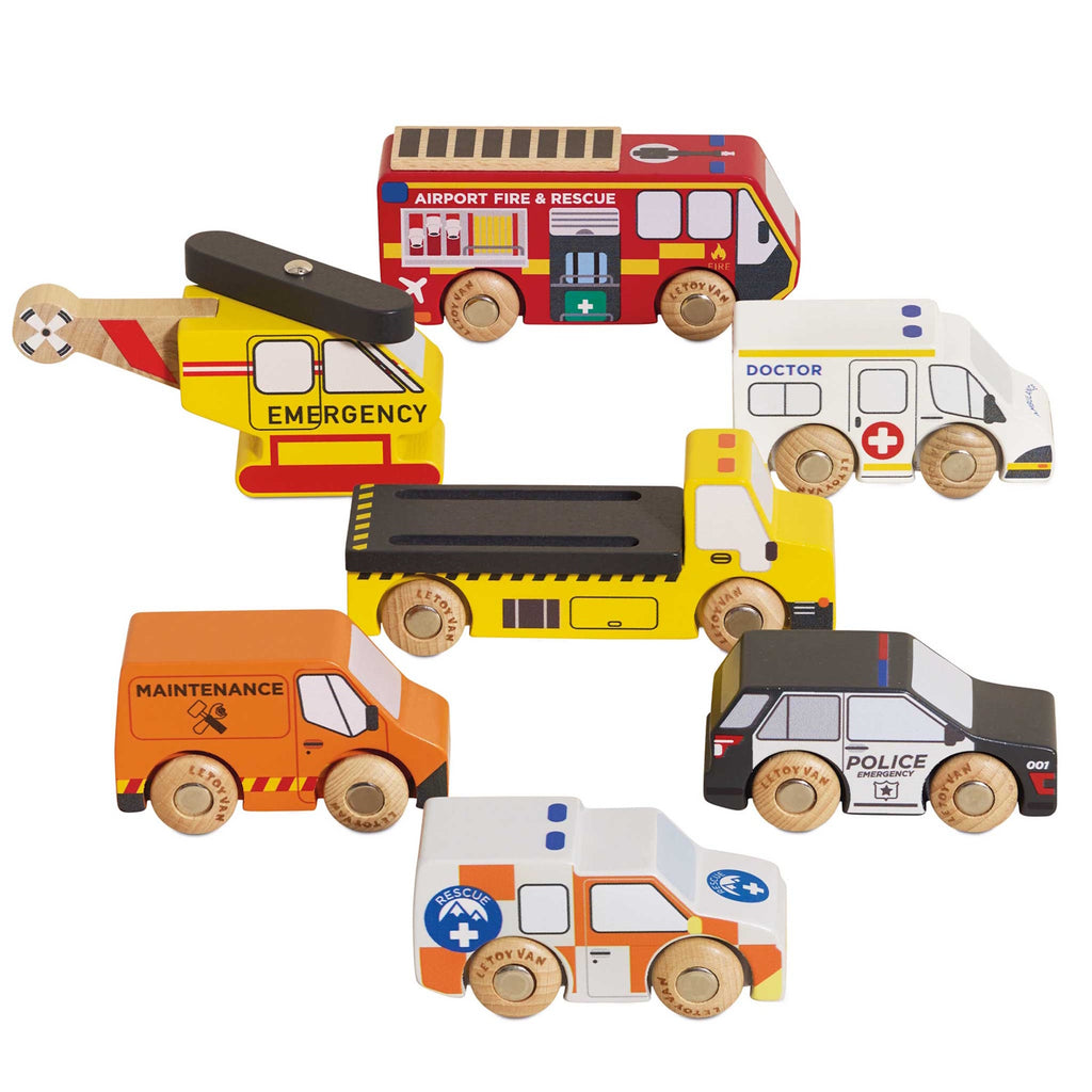 Toy wooden vehicles, including a yellow emergency helicopter, fire truck, maintenance van, dump truck, police car, ambulance, and rescue vehicle, each with colorful details.