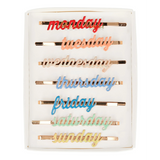 A set of enamel hair clips featuring the days of the week, perfect for adding a fun and functional touch to daily hairstyles.