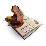 Pop-up book open to a page with a fierce, colorful 3D dinosaur head emerging. Bright colors and dynamic paper engineering create an exciting, playful tone.