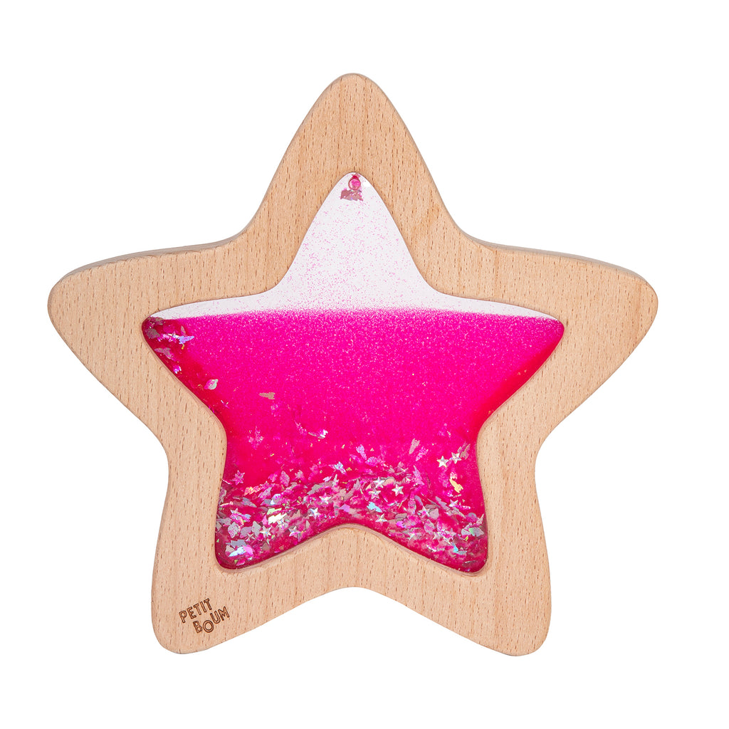  A wooden star-shaped sensory toy filled with vibrant pink glittery liquid, designed for visual stimulation.