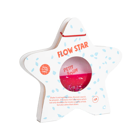 A star-shaped wooden sensory toy by Petit Boum, featuring pink glittery liquid inside, with packaging labeled "Flow Star" and "Glow in the Dark."