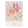 Packaged Meri Meri fairy cake toppers featuring paper fairies, tissue paper flowers, and a toadstool on wooden picks.