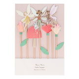 Packaged Meri Meri fairy cake toppers featuring paper fairies, tissue paper flowers, and a toadstool on wooden picks.