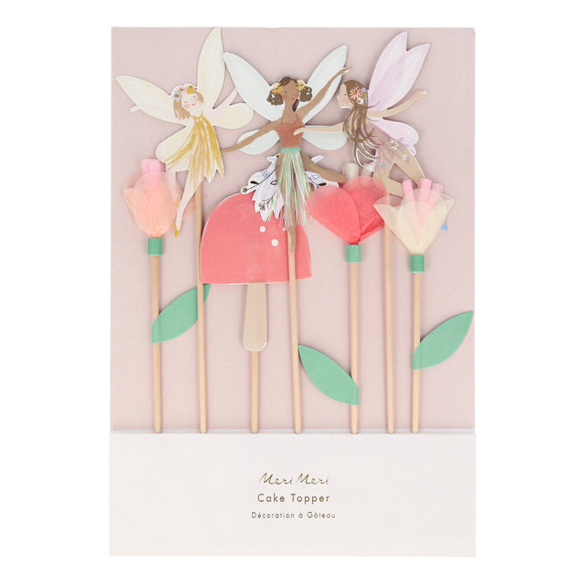 Packaged Meri Meri fairy cake toppers featuring paper fairies, tissue paper flowers, and a toadstool on wooden picks.