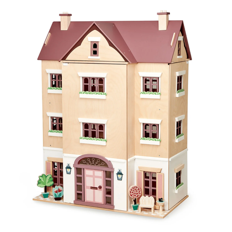 Closed multi-storey wooden dollhouse featuring a front door, windows, and potted plants.