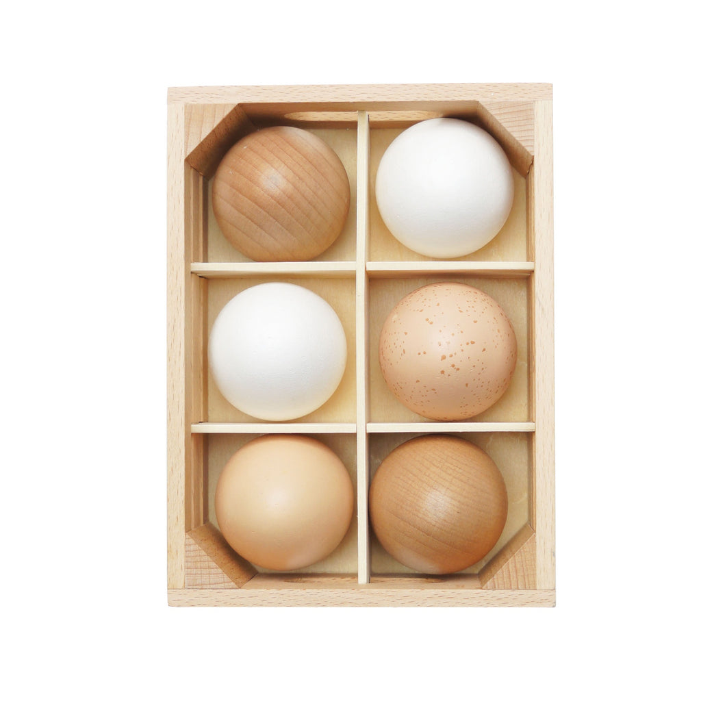 Wooden crate holding five toy eggs in white, tan, and speckled brown.