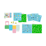 Board game components are spread out, featuring colorful cards, a booklet titled "Farty Facts," bingo boards, counters, and a playful green pattern theme.