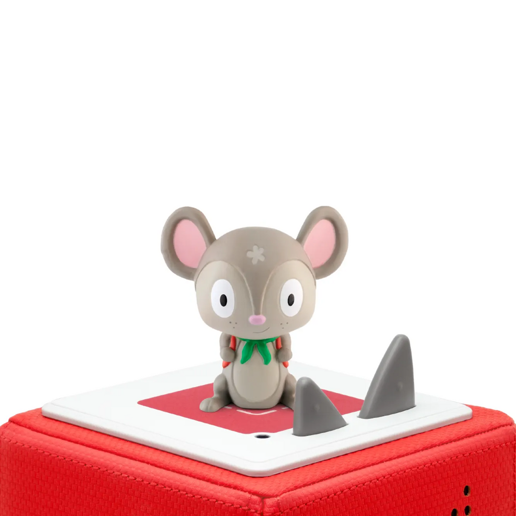 A cute gray mouse figurine with large eyes and pink ears, wearing a green scarf and red backpack, sitting cheerfully.