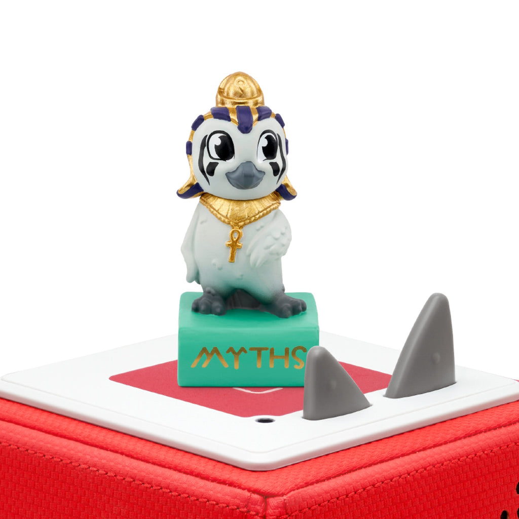 A cute penguin figurine dressed as an Egyptian pharaoh stands on a green book labeled "MYTHS" audiobook.