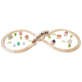 Wooden figure-of-8 train track set with a toy train crossing a bridge, houses, and trees.