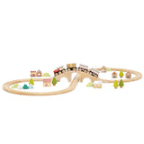 Wooden figure-of-eight train set with a bridge, train cars, trees, tents, and small buildings.