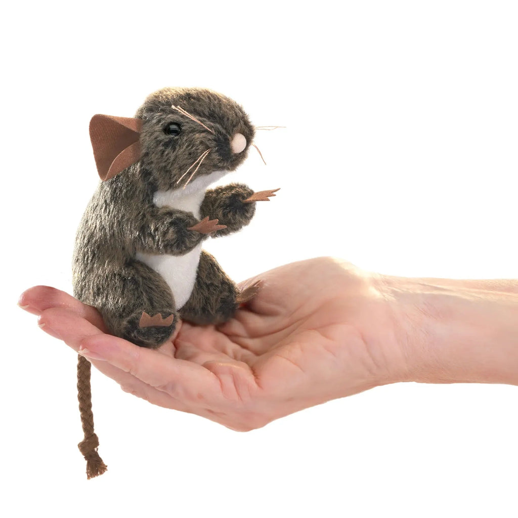 A hand holding a realistic brown mouse finger puppet with large ears and a long tail. The puppet appears lifelike and detailed, conveying playfulness.