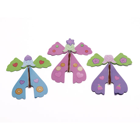 Three colorful paper flying fairies with rubber band mechanisms lined up on a white background.
