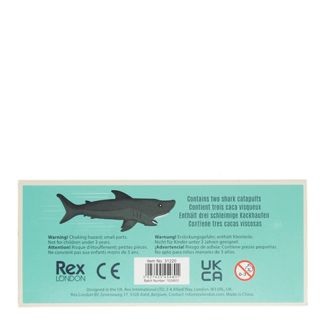 Back packaging for Rex London shark finger catapults showing safety warnings and product info.