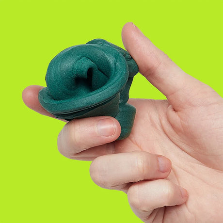 Hand holding a folded mound of dark-green focus putty against a bright lime-green background.