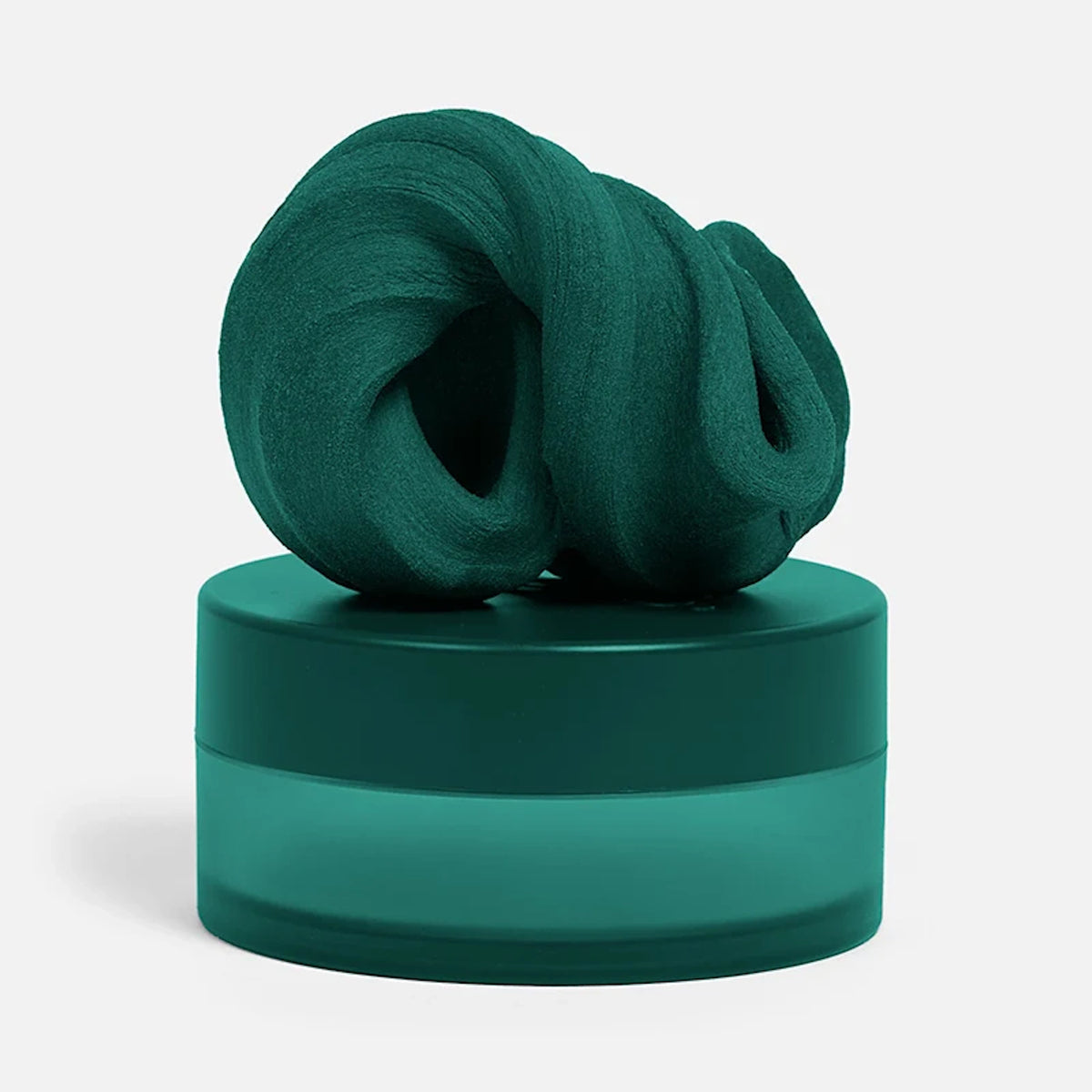 Swirled dark-green focus putty sitting on top of its matching circular container.