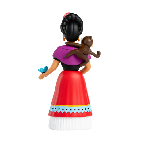 Rear view of a stylized female figurine with a braided bun, wearing a purple shawl, red skirt, and white blouse. A monkey sits on her shoulder, and a blue butterfly rests on her hand. The background is white.