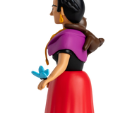 A stylized figurine with a colorful design featuring a woman in a purple shawl and red dress, a monkey on her shoulder, and a blue butterfly on her hand.