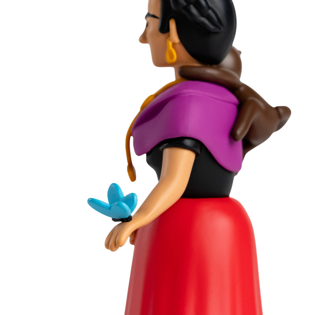 A stylized figurine with a colorful design featuring a woman in a purple shawl and red dress, a monkey on her shoulder, and a blue butterfly on her hand.