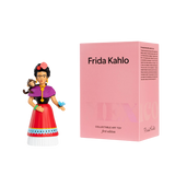 A colorful Frida Kahlo figurine, with a monkey on her shoulder and a butterfly in hand, stands beside a pink box labeled "Frida Kahlo, Collectable Art Toy."