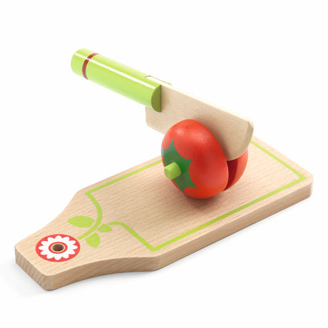 Wooden play food set featuring a toy tomato, cutting board, and knife for toddlers' kitchen roleplay.