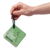 A hand holding a green card deck titled "100 Fun Things To Do With a stick" on a dark green loop clip.