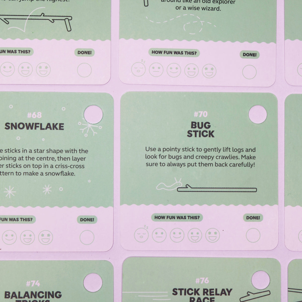Green activity prompt cards featuring stick ideas like "Snowflake" and "Bug Stick" on a purple surface.