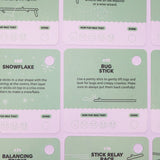 Green activity prompt cards featuring stick ideas like "Snowflake" and "Bug Stick" on a purple surface.