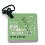 A green activity card booklet titled "100 Fun Things To Do With a stick" attached to a carabiner ring.