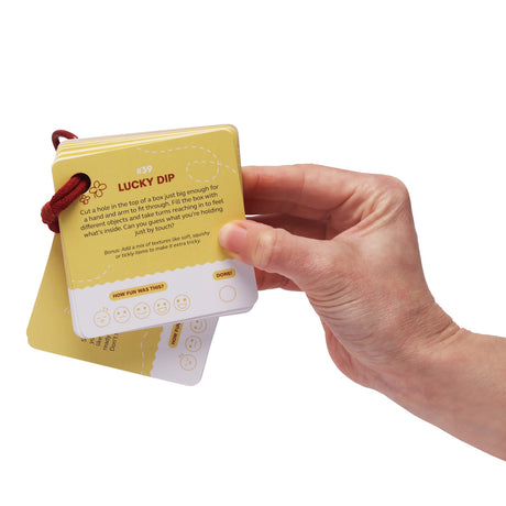 Hand holding a yellow activity card ring showing card #39 "Lucky Dip" with instructions.