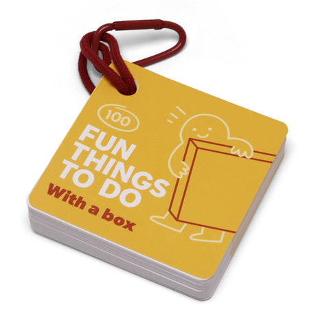 Yellow card deck titled "100 Fun Things To Do With a box" held together by a red carabiner clip.