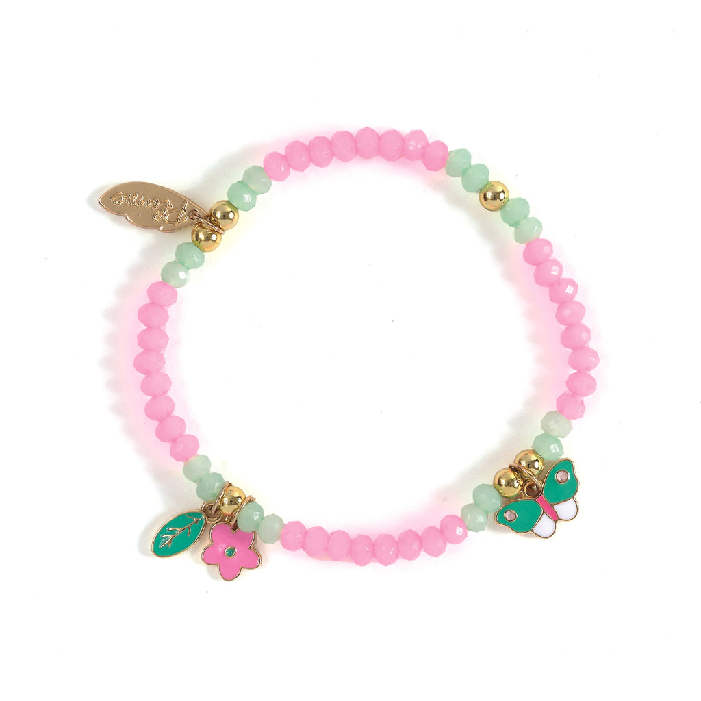 A colorful bracelet with pink and green beads, adorned with gold accents. Charms include a butterfly, flower, leaf, and an engraved tag, evoking a playful feel.
