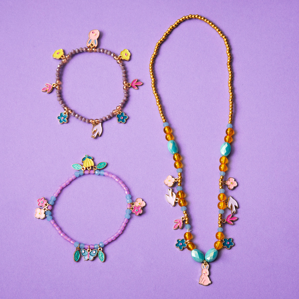 Girls garden collection jewelry set with two beaded charm bracelets and a long necklace featuring floral and bunny charms.