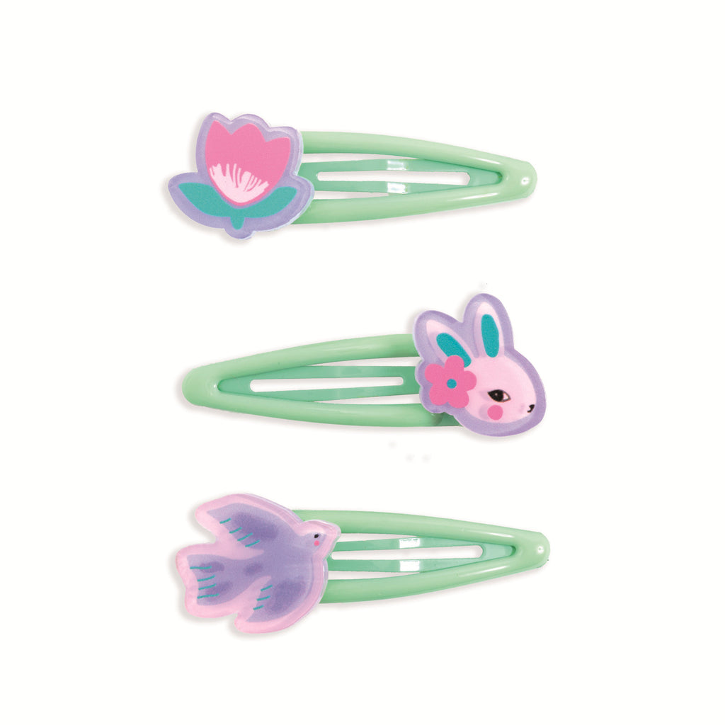 Three green hair clips with playful designs, a pink flower, a pink-eared bunny with a flower, and a purple bird. Cute and whimsical tone.