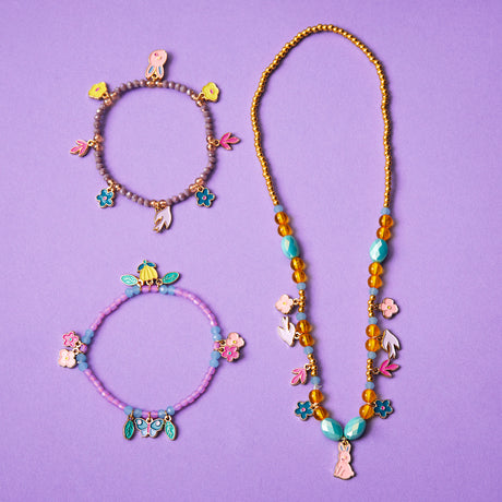 Girls garden collection jewelry set with two beaded charm bracelets and a long necklace featuring floral and bunny charms.
