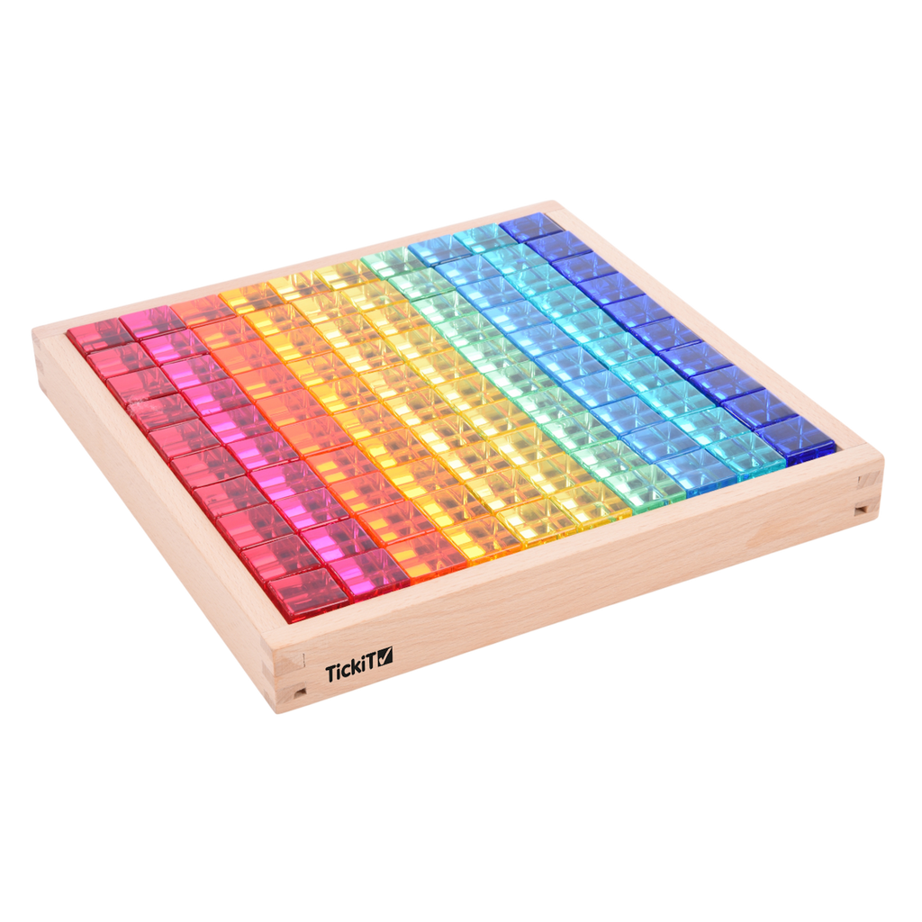 A square wooden tray with a mirrored base and colorful gem-like insets, designed to inspire sensory exploration, pattern making, and visual play.