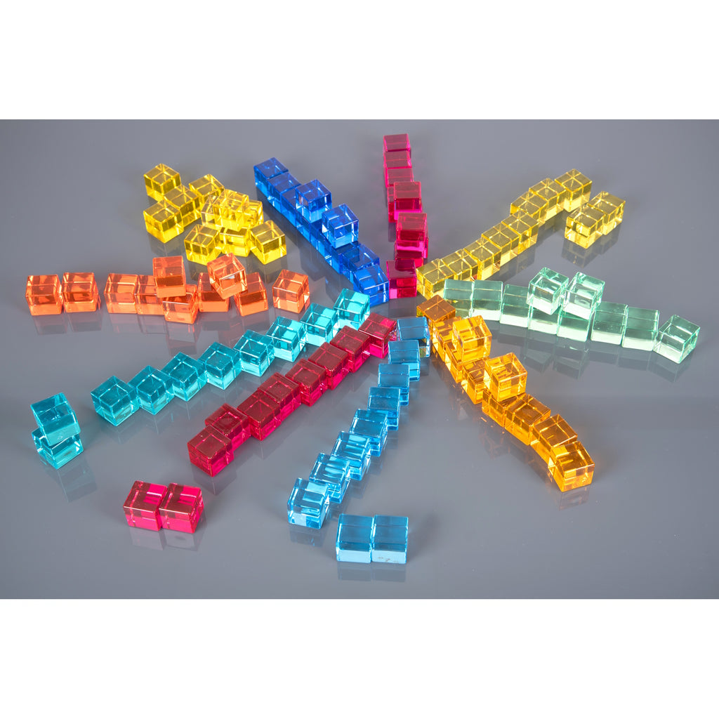 A square wooden tray with a mirrored base and colorful gem-like insets, designed to inspire sensory exploration, pattern making, and visual play.