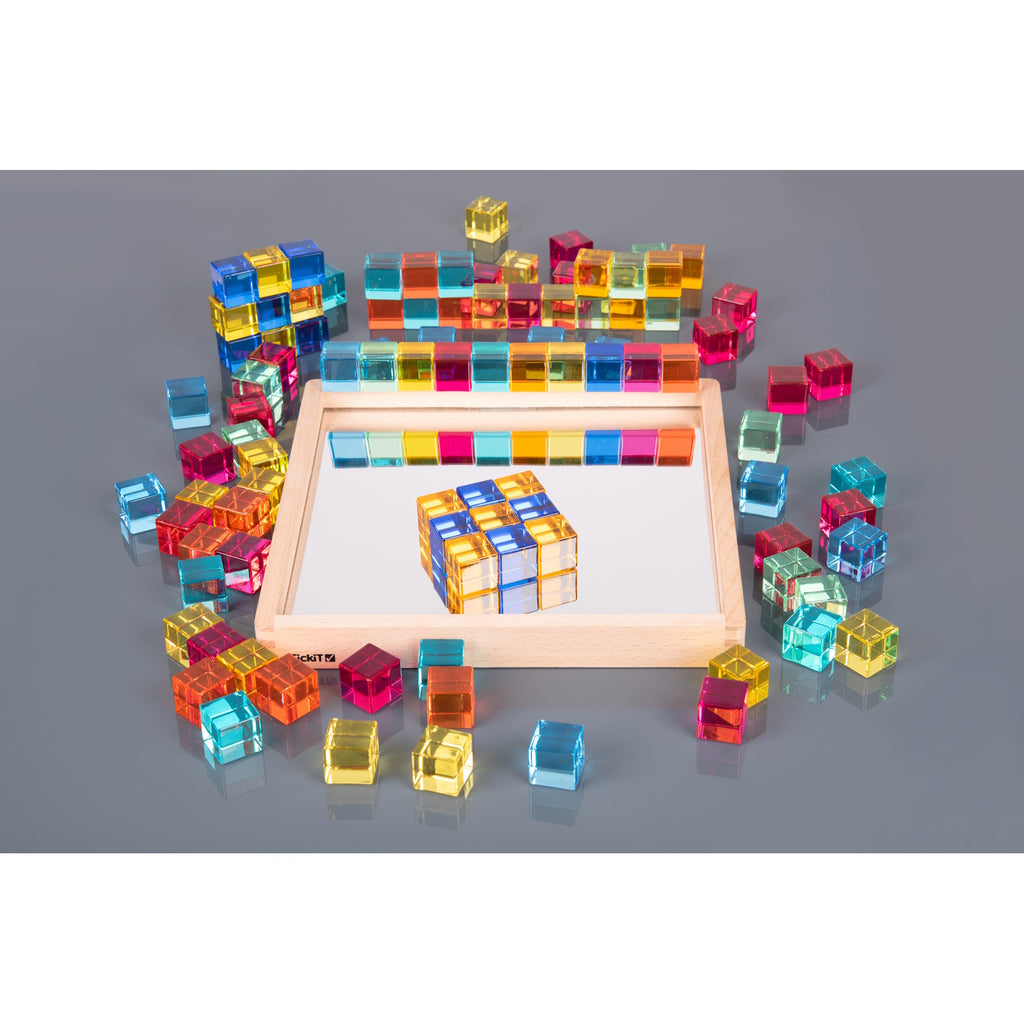 A square wooden tray with a mirrored base and colorful gem-like insets, designed to inspire sensory exploration, pattern making, and visual play.